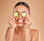 Skincare, cucumber on eyes and face of woman with smile for wellness, facial treatment and natural cosmetics. Beauty, spa aesthetic and happy girl with vegetable for detox, vitamin c and dermatology