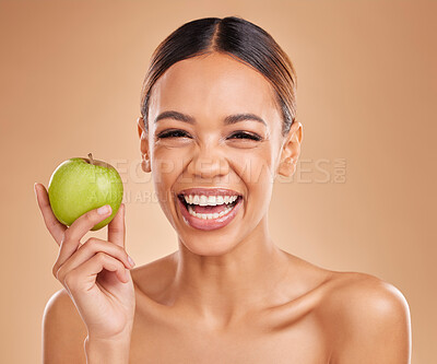 Buy stock photo Portrait, beauty and woman with skincare, apple and smile with girl against brown studio background. Portrait, female and lady with fruit, diet and cosmetics with happiness, healthy lifestyle or joy