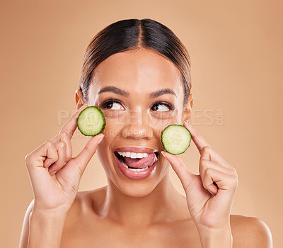 Buy stock photo Skincare, holding cucumber and face of woman with smile for wellness, facial treatment and natural cosmetics. Beauty, spa aesthetic and happy girl with fruit for detox, vitamin c and health in studio