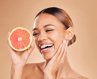 Buy stock photo Skincare, grapefruit and face of woman with smile in studio for wellness, facial treatment and natural cosmetics. Beauty, spa aesthetic and happy girl with fruit for detox, vitamin c and healthy skin