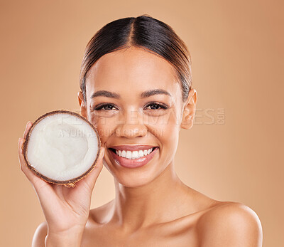 Buy stock photo Skincare, coconut and portrait of woman with smile for wellness, facial treatment and natural cosmetics. Beauty, dermatology spa and happy girl with fruit for detox, organic and nutrients in studio