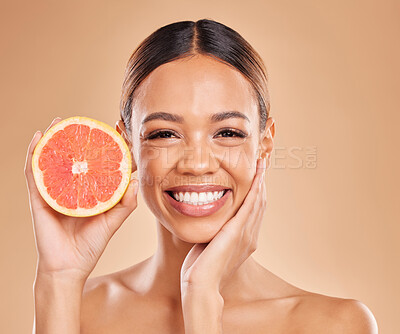 Buy stock photo Skincare, grapefruit and face of woman with smile in studio for wellness, facial treatment and natural cosmetics. Beauty, spa aesthetic and happy girl with fruit for detox, vitamin c and healthy skin