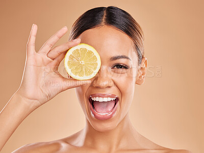 Lemon, skincare and face of woman with excited smile in studio for wellness, facial treatment and natural cosmetics. Beauty, spa and happy girl with fruit slice for detox, vitamin c and dermatology