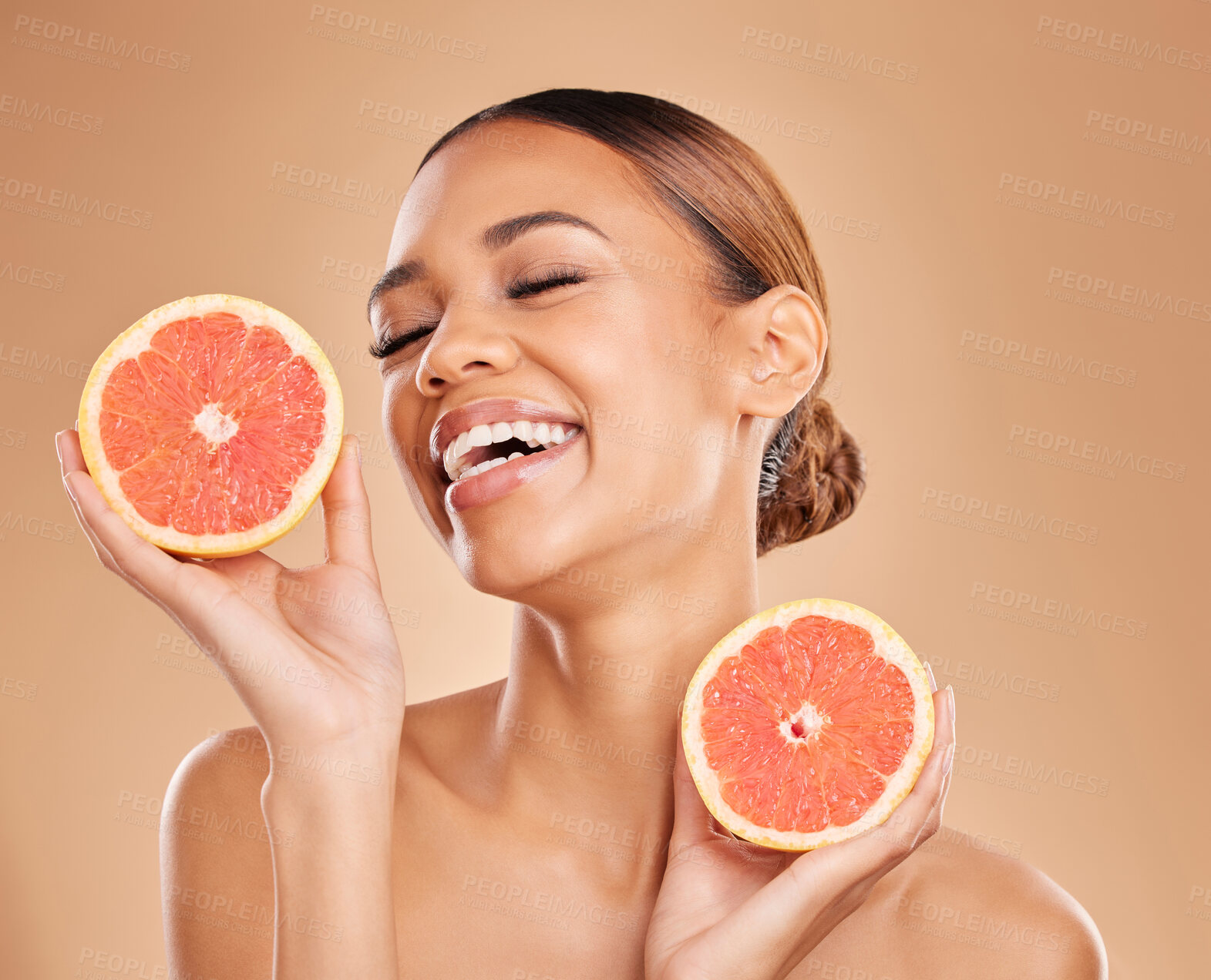 Buy stock photo Skincare, grapefruit and face of woman with laugh in studio for wellness, facial treatment and natural cosmetics. Beauty, spa aesthetic and happy girl with fruit for detox, vitamin c and dermatology