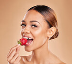 Skincare portrait, eating or woman with strawberry in studio on beige background for healthy nutrition or clean diet. Healthcare, face or beautiful girl model or marketing natural fruits for wellness
