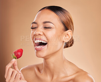 Beauty, skincare or funny woman with strawberry in studio on beige background for healthy nutrition or clean diet. Smile, happy or girl model laughing with natural fruits for nutrition or wellness