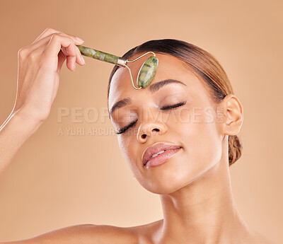 Buy stock photo Girl, beauty or face massage with roller, facial product for healthy skincare on studio background. Relaxing, crystal stone treatment or natural model woman with dermatology cosmetics or wellness