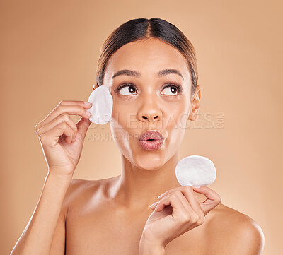 Buy stock photo Skincare, dermatology and woman with cotton pad, organic facial and treatment against a brown studio background. Female, lady and makeup remover with cosmetics, grooming and wellness with smooth skin