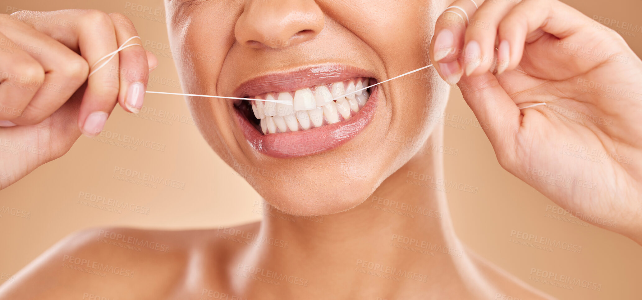 Buy stock photo Flossing, smile and a woman with dental care for teeth isolated on a studio background. Happy, healthcare and the mouth of a girl with a routine oral hygiene cleaning, treatment and tooth floss