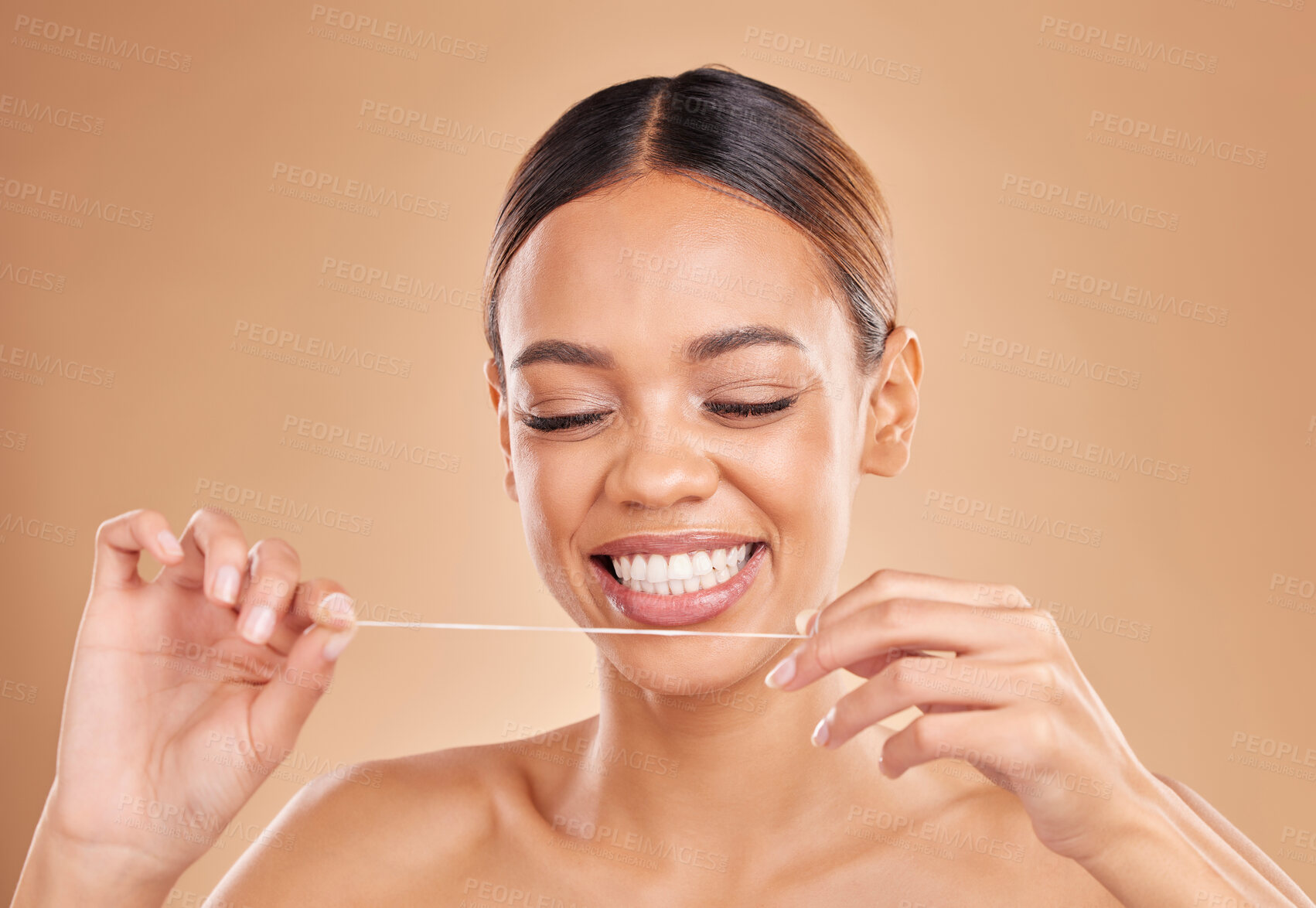 Buy stock photo Happy, dental floss and woman in studio for teeth, cleaning and oral hygiene against brown background. Mouth, flossing and girl model with thread for tooth, decay and prevention while posing isolated