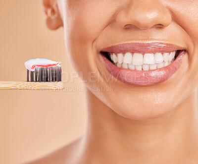 Buy stock photo Toothpaste, bamboo toothbrush and smile of woman in studio isolated on a brown background. Sustainable, eco friendly and face of happy female with wood brush for brushing teeth and dental health.