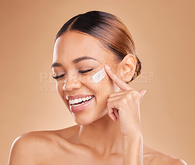 Funny, face skincare and woman with cream in studio isolated on a brown background. Dermatology, beauty cosmetics and happy female model apply lotion, creme or facial moisturizer for skin health.