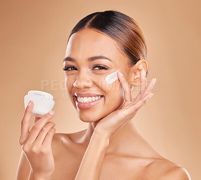 Buy stock photo Skincare, face and woman with cream container in studio isolated on a brown background. Dermatology portrait, cosmetics or happy female model apply lotion, creme or moisturizer product of skin health