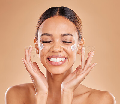Buy stock photo Face smile, skincare and woman with cream in studio isolated on a brown background. Dermatology, beauty cosmetics and happy female model with lotion, creme or moisturizer product for skin health.