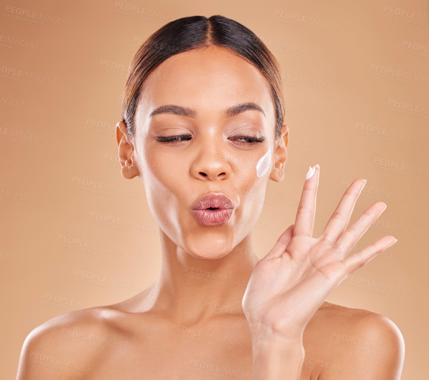 Buy stock photo Beauty, face cream and a woman in studio for skincare with dermatology, cosmetics or makeup. Happy aesthetic female model on a brown background for self care, skin glow and facial wellness lotion