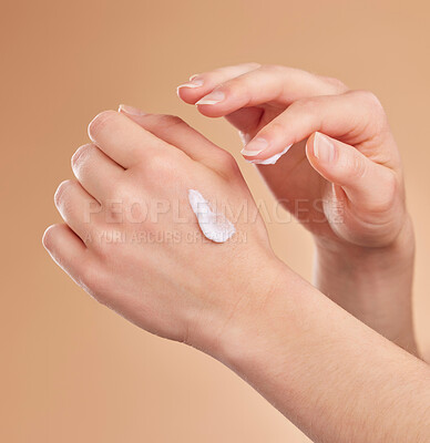 Buy stock photo Hands, skincare and beauty cream in studio isolated on a brown background. Dermatology, cosmetics and woman or female model apply lotion, creme or moisturizer product for skin health or hydration.