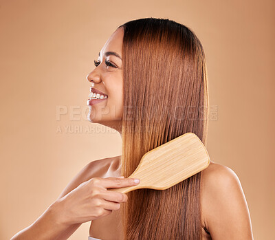 Buy stock photo Beauty, woman and brush hair for growth and shine for straight texture on a brown background. Smile of aesthetic female happy in studio brushing for natural keratin treatment haircare results