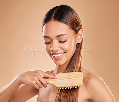 Buy stock photo Woman, beauty and brushing hair for growth and shine for healthy texture on a brown background. Smile of aesthetic female happy in studio with a brush for natural keratin treatment haircare results