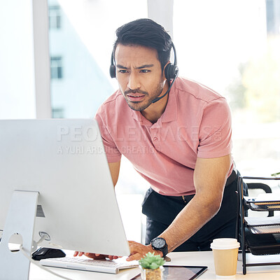 Buy stock photo Serious asian man, call center and computer in customer service or problem solving at office desk. Confused male consultant or agent standing by PC in telemarketing research or browsing with headset