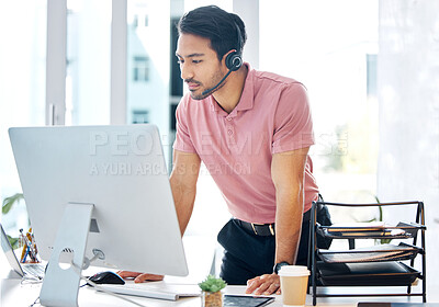 Buy stock photo Serious asian man, call center and computer in customer service or desktop support at office desk. Male consultant agent standing by PC in telemarketing advice or decision with headset at workplace