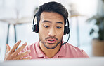 Asian man, call center and consulting with headphones on computer for customer service, help or support at office. Male consultant agent talking with headset on PC for telemarketing or online advice