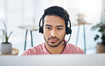 Serious asian man, call center and headset on computer for consulting, customer service or support at office. Focused male consultant with headphones by desktop PC for telemarketing or online advice