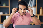 Serious asian man, call center and headset on laptop for consulting, customer service or support at office desk. Focused male consultant putting on headphones by computer for telemarketing or advice