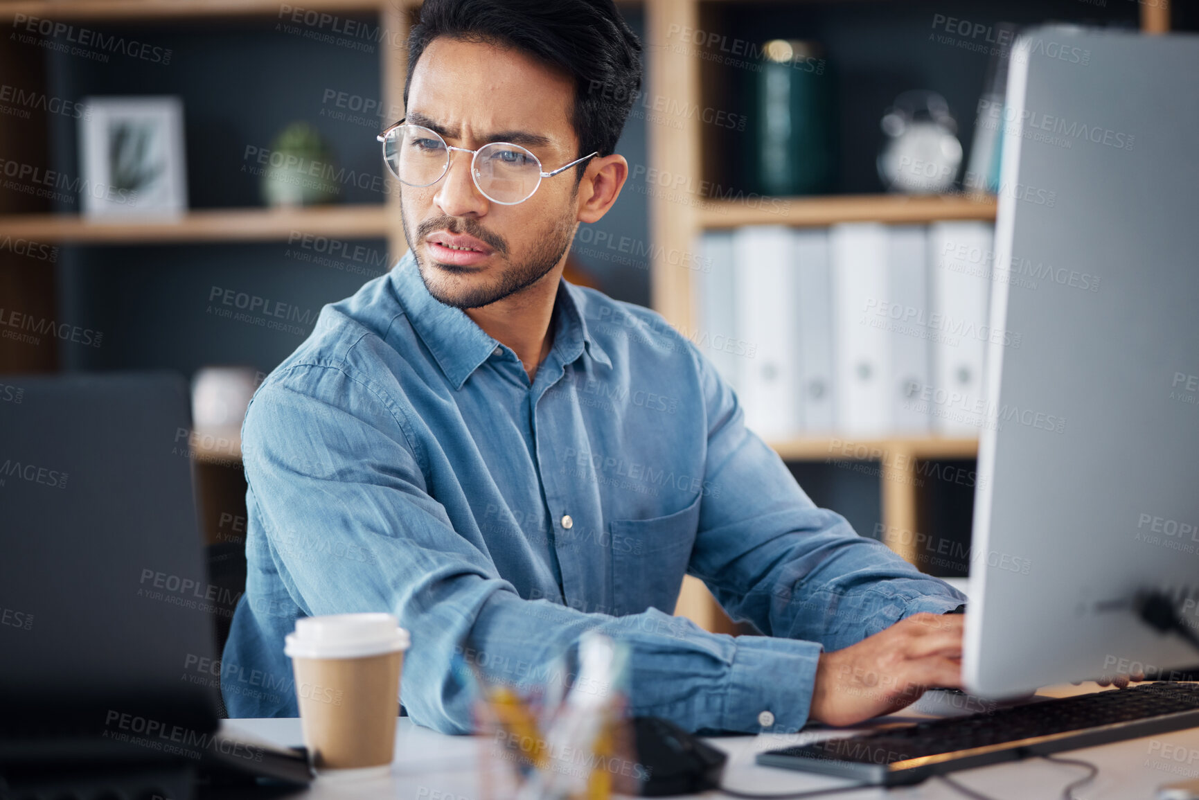 Buy stock photo Serious, business man working on computer, laptop and software development, digital research and information technology. Coding developer or asian person typing on desktop for multimedia management 