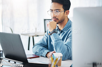 Buy stock photo Serious, business man and thinking on laptop in office, startup company or agency. Focused male employee, computer and solution of inspiration, ideas or planning goals of decision, review or strategy