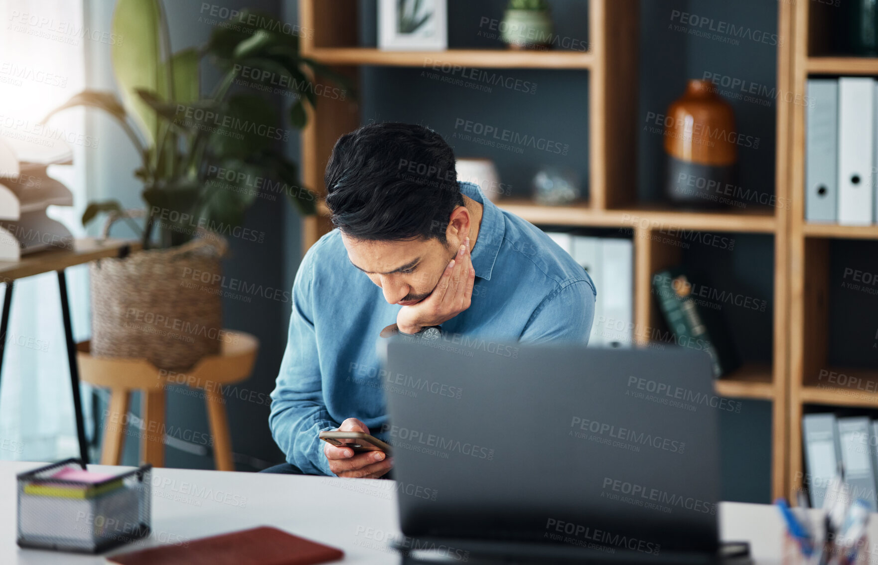 Buy stock photo Bored, phone and businessman in his office networking on social media, mobile app or the internet. Technology, professional and tired male employee browsing on a website with a cellphone in workplace