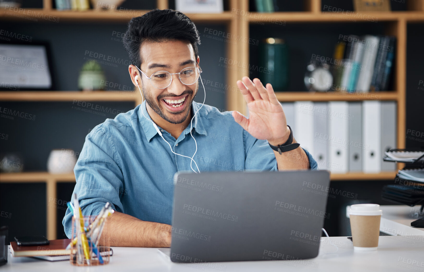 Buy stock photo Happy asian man, laptop and smile for video call or communication with earphones at office desk. Male creative designer smiling and waving for webinar, meeting or networking on computer at workplace