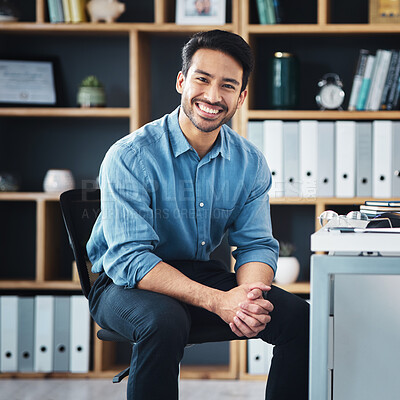 Buy stock photo Relax, break and portrait of businessman smile and sitting in startup company office excited for the future. Young, happy and professional man employee or worker feeling confident, proud