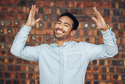 Buy stock photo Happy, excited and portrait of asian man and brick wall background for confidence, trendy and natural. Pride, cool and style with male and arms up for laughing, happiness and goofy expression