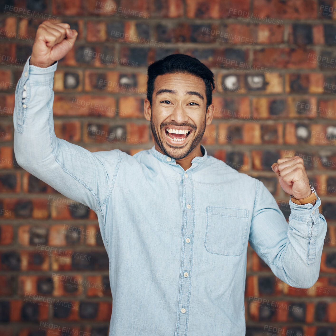 Buy stock photo Portrait, winner and motivation with a man in celebration against a brick wall background enjoying victory. Energy, wow and success with a handsome young man celebrating an achievement or bonus