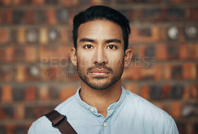 Buy stock photo Serious, confidence and portrait of a businessman in the office standing by a brick wall. Pride, professional and face of an Indian corporate male employee or expert with success in modern workplace.