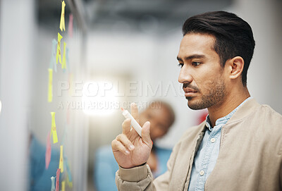 Buy stock photo Asian man, thinking and planning business schedule for brainstorming, project or tasks at the office. Thoughtful creative male with marker for idea strategy, decision or sticky note plan on board