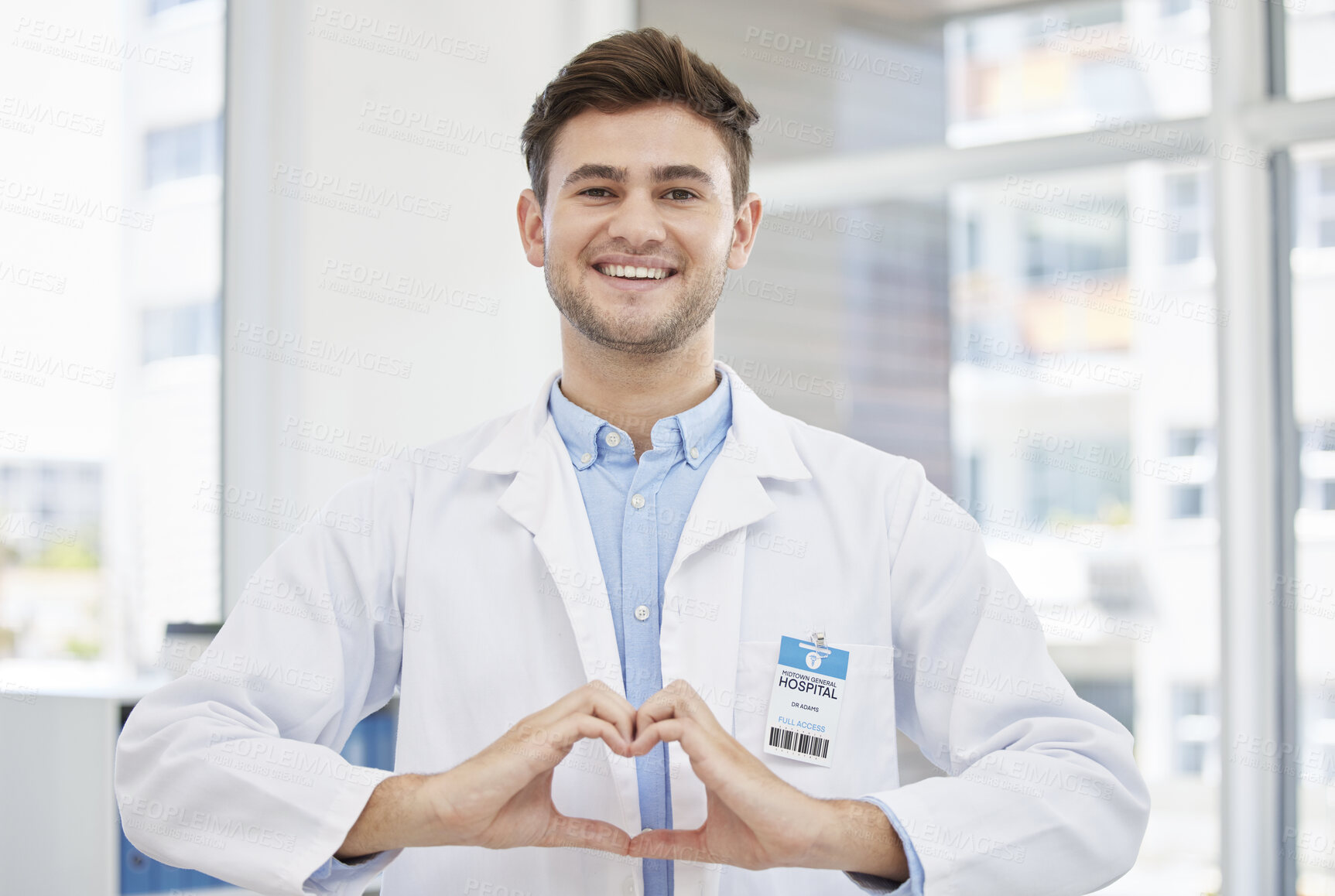Buy stock photo Healthcare, hands in heart and portrait of doctor in hospital with emoji for wellness, medicine and medical care. Smile, love gesture and happy man in clinic for consulting, insurance and support