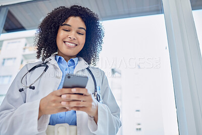 Buy stock photo Phone, healthcare and woman doctor with mobile app, network or telehealth service for hospital management. Medical professional or biracial person typing on cellphone or smartphone in clinic below
