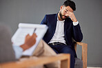 Sad man consulting therapist in therapy, psychology or counseling for mental health, debt or career stress support. Checklist, evaluation and psychologist with business person or patient consultation