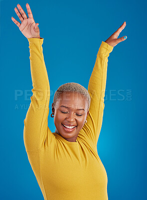 Buy stock photo Black woman, happy and freedom celebration in studio with a smile of a winner with hands raised. African female celebrate freedom, energy dance and mindset winning prize or lottery on blue background