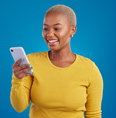 Buy stock photo Phone, happy and black woman typing in studio for social media, text message and browse website. Communication mockup, technology and girl on internet, networking and chat online on blue background