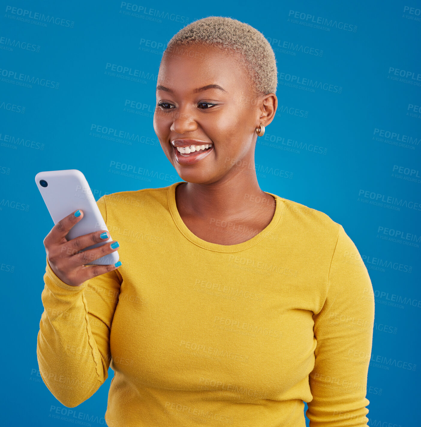 Buy stock photo Phone, happy and black woman typing in studio for social media, text message and browse website. Communication mockup, technology and girl on internet, networking and chat online on blue background