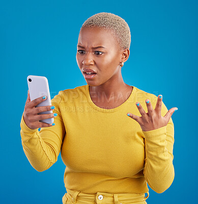 Buy stock photo Phone, wtf and confused black woman in studio for fake news, social media and text on blue background. Omg, scam and girl with smartphone notification for phishing alert, glitch or internet problem