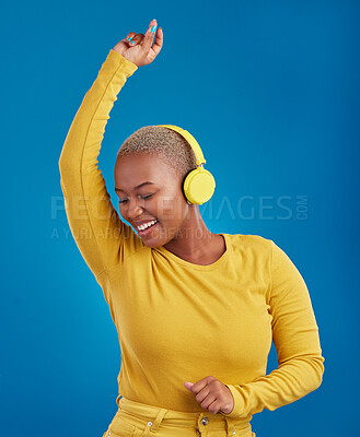 Buy stock photo Black woman with headphones, dancing and listening to music, rhythm and fun with freedom on blue background. Happy female with yellow aesthetic, streaming radio with dance and carefree in studio