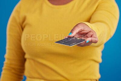 Buy stock photo Credit card, payment and woman hand in a studio ready for finance expenses and sales. Isolated, blue background and paying with a female model showing financial banking method for ecommerce sale