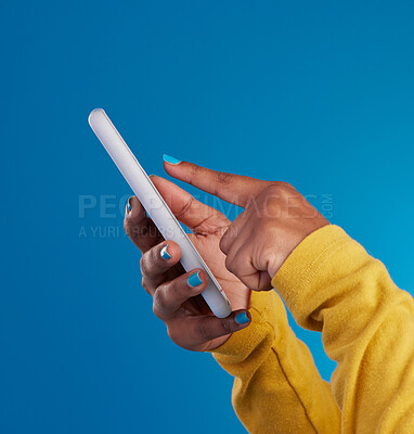 Buy stock photo Phone, typing and hands of woman point to screen in studio for social media, text message and website. Communication, technology and girl on internet, networking and chat online on blue background