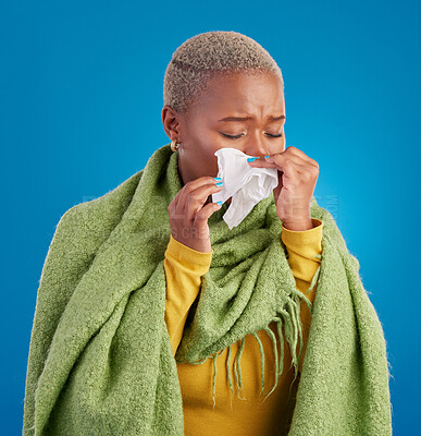 Buy stock photo Sick black woman, tissue and blowing nose in studio, blue background or hayfever allergies, cold or winter virus. Female model, sneeze and influenza allergy of health problem, covid risk or sinusitis