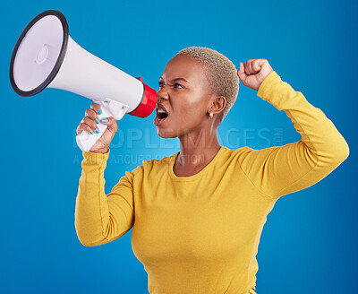 Buy stock photo Megaphone, black woman and screaming in studio with fist of power, broadcast or vote on blue background. Speaker, microphone and girl protest for change, democracy or justice, noise or womens rights