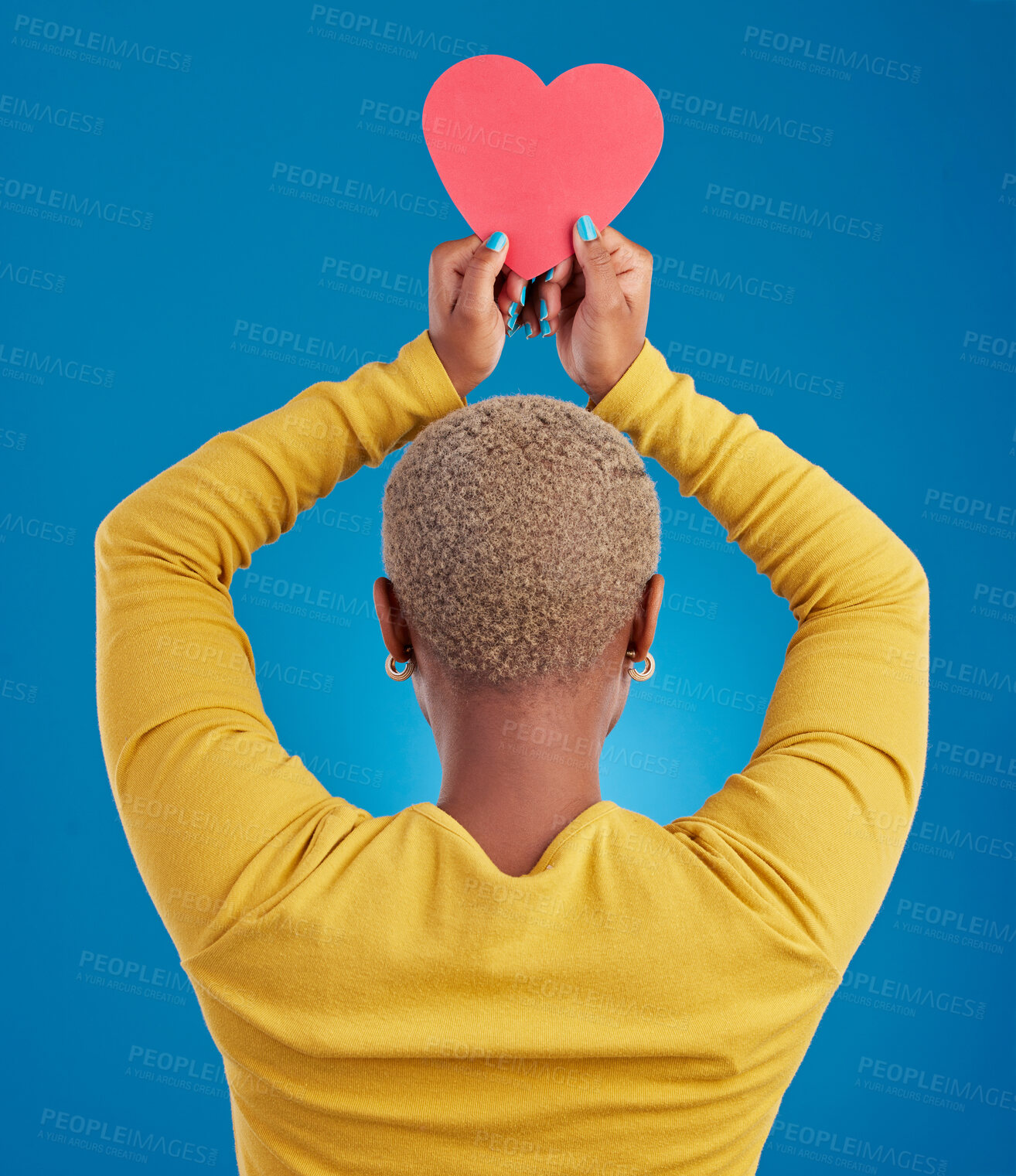 Buy stock photo Paper, heart and back of black woman in studio for love, date and kindness. Invitation, romance and feelings with female and shape isolated on blue background for emotion, support and affectionate