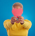 Paper, heart and cover with black woman in studio for love, date and kindness. Invitation, romance and feelings with female and shape isolated on blue background for emotion, support and affectionate